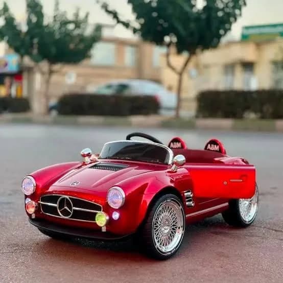 Red Mercedes-Benz kids ride-on car with black windscreen and four wheels