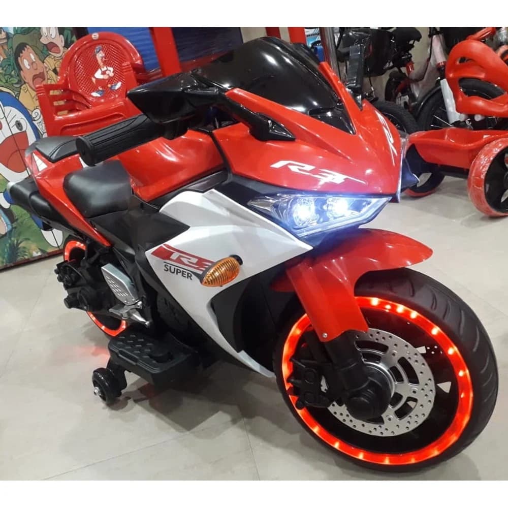 Red and white R3-style kids ride-on sports bike with glowing wheels
